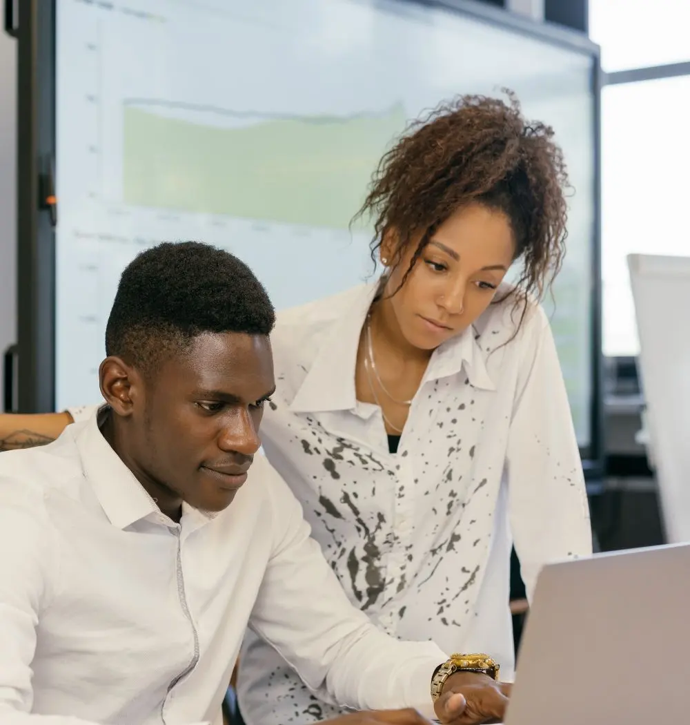 Colleagues planning a project together around a laptop
